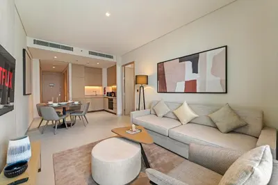a living room with a couch and a table at Vida Residences Dubai Mall Spacious 1BR Apartment in Dubai