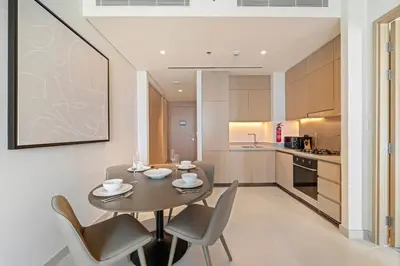 a kitchen and dining room with a table and chairs at Vida Residences Dubai Mall Spacious 1BR Apartment in Dubai