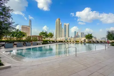 a swimming pool with a city skyline in the background at Vida Residences Dubai Mall Spacious 1BR Apartment in Dubai