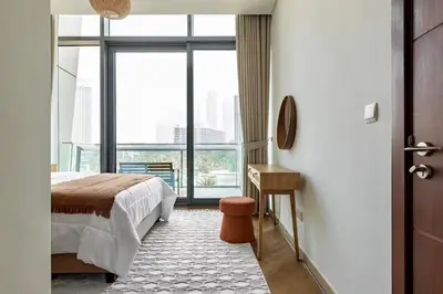 a bedroom with a bed and a floor to ceiling window at Urban Luxury Burj Vista Apartments Direct Burj Khalifa View in Dubai