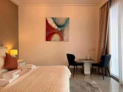 a bedroom with a bed and a table with chairs at Urban Luxury Burj Vista Apartments Direct Burj Khalifa View in Dubai
