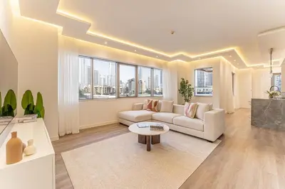 a living room with a couch and a table at HAVN - 3 Bedroom in Downtown, Burj Khalifa View in Dubai
