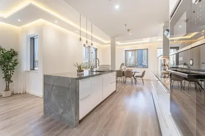 a kitchen and dining room with a large island at HAVN - 3 Bedroom in Downtown, Burj Khalifa View in Dubai