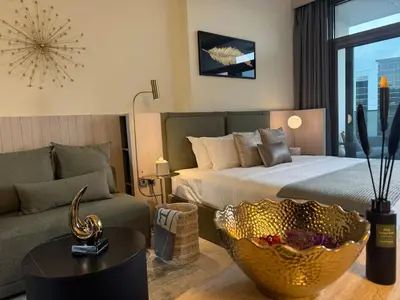 a hotel room with a bed and a couch at MAG 318 Luxury Studio Resort Style Amenities in Dubai