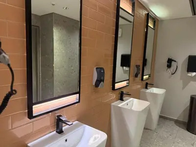 a bathroom with two sinks and two mirrors at MAG 318 Luxury Studio Resort Style Amenities in Dubai