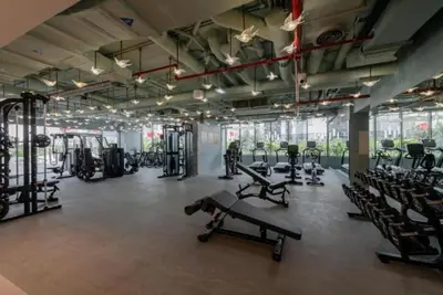 a gym with several treadmills and machines in it at MAG 318 Luxury Studio Resort Style Amenities in Dubai