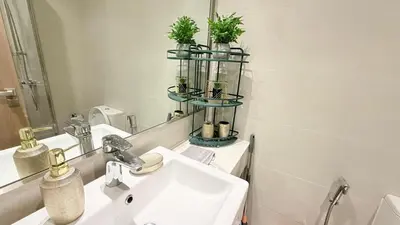 a bathroom with a sink and a mirror at Luxure Studio with Pool View in Dubai