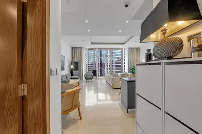 a living room with a kitchen and a living room at Waves - Grand Palm Escape - Sea-View Massive 1BR Luxury in Dubai