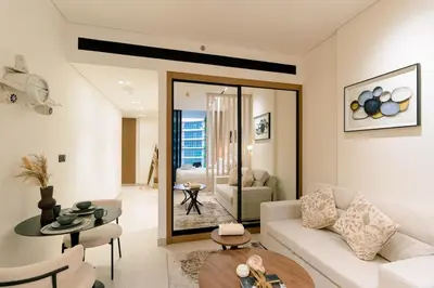 a living room with a white couch and a table at Stylish central apartment, own Jaccuzi, burj view in Dubai