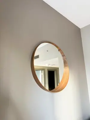 a round mirror on a white wall in a room at 4 Person - Resort Canal View - CBD Parking Pool in Dubai