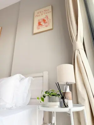 a bedroom with a white bed and a table with a lamp at 4 Person - Resort Canal View - CBD Parking Pool in Dubai