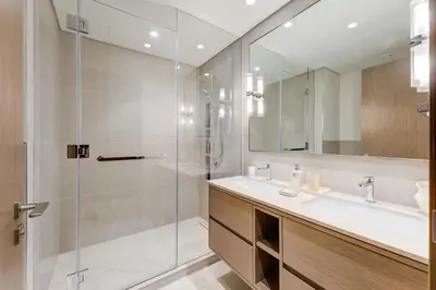 a bathroom with a glass shower and a sink at Ultra-Luxury 2BR with Burj Khalifa view Downtown in Dubai