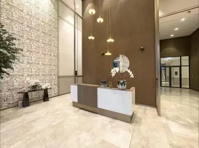 a lobby with a reception desk and a brick wall at Ultra-Luxury 2BR with Burj Khalifa view Downtown in Dubai
