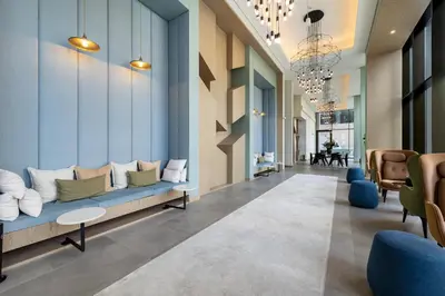 a lobby with a blue couch and chairs at Luxury High-Floor Canal View near Burj Khalifa in Dubai