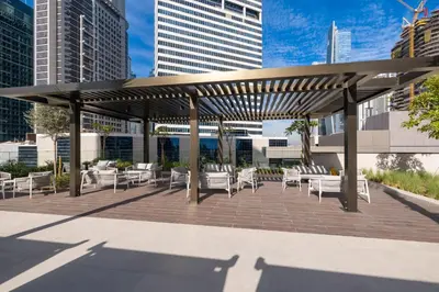 a pavilion with chairs and tables in a city at Luxury High-Floor Canal View near Burj Khalifa in Dubai