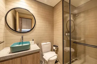 a bathroom with a toilet and a sink and a mirror at Luxury High-Floor Canal View near Burj Khalifa in Dubai