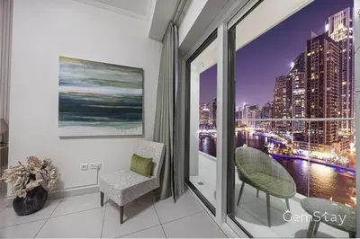 a room with a window with a view of a city at Beautiful Marina Skyline Serenity Spacious n Bright in Dubai