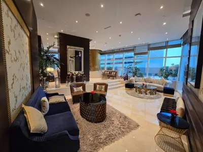 a large living room with a blue couch and chairs at Beautiful Marina Skyline Serenity Spacious n Bright in Dubai