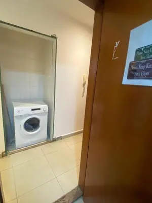 a bathroom with a washing machine in a stall at City Stay Partition Room in Barsha Heights tecom in Dubai