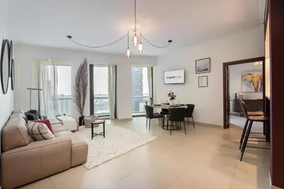 a living room with a couch and a table at Premium 1BR in Downtown & Direct Access to Metro in Dubai