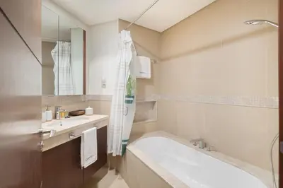 a bathroom with a tub and a sink at Premium 1BR in Downtown & Direct Access to Metro in Dubai