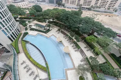 an overhead view of a swimming pool in a city at Premium 1BR in Downtown & Direct Access to Metro in Dubai
