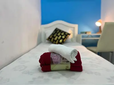 a stuffed animal with a towel on a bed at Smart Stay Partition Room In Barsha Heights Tecom in Dubai