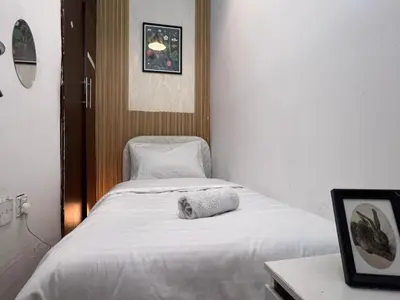 a room with a bed with a towel on it at Affordable Partition Room In Barsha Heights Tecom in Dubai