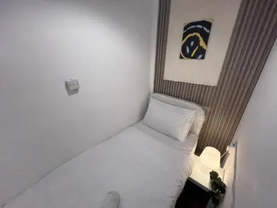 a small bedroom with a small bed in a room at Skyline Stay Partition Room In Barsha Heights Tecom in Dubai