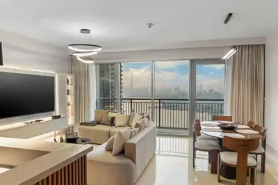 a living room with a couch and a tv and a table at Luxury Apartment - Burj Khalifa, Creek - Best View in Dubai