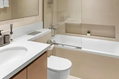 a bathroom with a toilet and a sink and a tub at Luxury Apartment - Burj Khalifa, Creek - Best View in Dubai