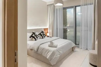 a bedroom with a bed and a large window at Luxury Apartment - Burj Khalifa, Creek - Best View in Dubai