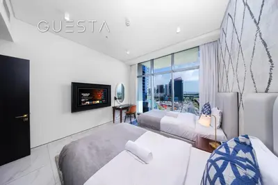a hotel room with two beds and a tv at Apartments at Millennium Atria, Business Bay in Dubai