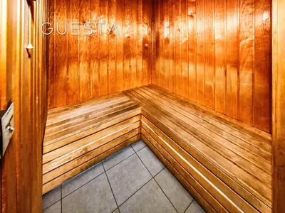 a corner of a wooden sauna with the words questasy at Apartments at Millennium Atria, Business Bay in Dubai