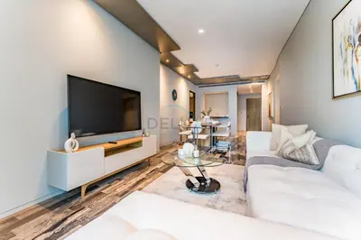 a living room with a white couch and a flat screen tv at High-Floor 3BR with Balcony Overlooking the Marina, Near the Beach, Just Minutes Walk to the Tram, Damac Heights, Dubai Marina by Deluxe Holiday Homes in Dubai
