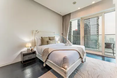 a bedroom with a large bed and a large window at High-Floor 3BR with Balcony Overlooking the Marina, Near the Beach, Just Minutes Walk to the Tram, Damac Heights, Dubai Marina by Deluxe Holiday Homes in Dubai