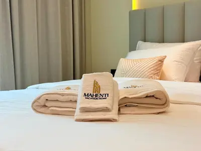 a hotel room with two towels on a bed at Mahenti - Stylish Urban Studio with Burj View in Dubai
