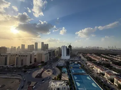 an aerial view of a city with buildings and roads at Mahenti - Stylish Urban Studio with Burj View in Dubai