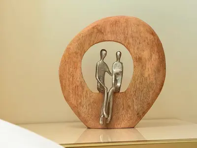 a metal sculpture of two people sitting in a circle at Mahenti - Stylish Urban Studio with Burj View in Dubai