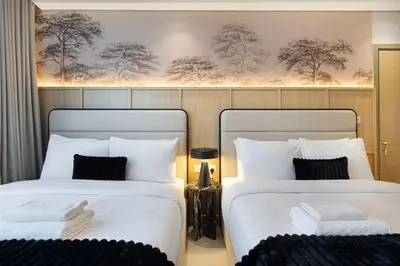 two beds sitting next to each other in a room at Premium 3BR Paramount Hotel Midtown Business Bay in Dubai