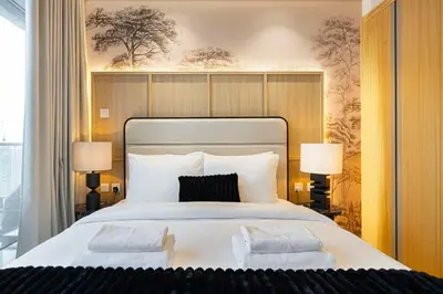 a bedroom with a large white bed with two pillows at Premium 3BR Paramount Hotel Midtown Business Bay in Dubai