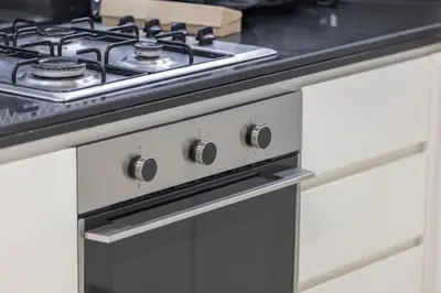 a stove top oven in a kitchen at Premium 3BR Paramount Hotel Midtown Business Bay in Dubai