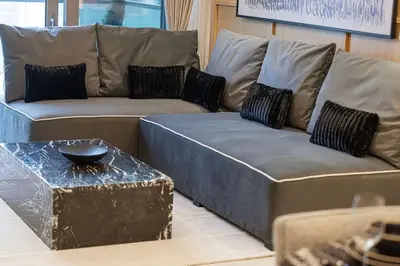 a living room with a couch and a table at Premium 3BR Paramount Hotel Midtown Business Bay in Dubai