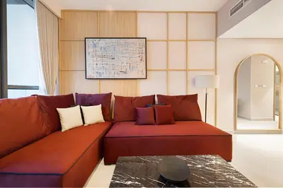 a brown couch in a living room with a table at Spacious 4BR for 12 Burj View PS5 Dubai Mall in Dubai