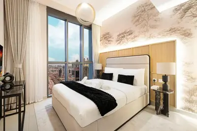a bedroom with a large bed and a large window at Spacious 4BR for 12 Burj View PS5 Dubai Mall in Dubai
