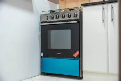 a black and blue oven in a kitchen at StayShort - Chic studio in Production City that sleeps 4 in Dubai