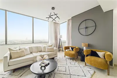 a living room with a couch and a table and chairs at Silkhaus 2BDR Heart of DIFC in Sky Gardens in Dubai