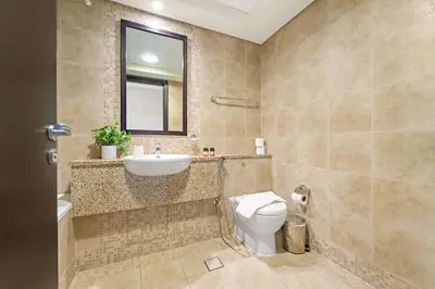 a bathroom with a sink and a toilet at Silkhaus 2BDR Heart of DIFC in Sky Gardens in Dubai