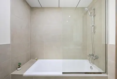 a bathroom with a shower with a bath tub at Bloomfields Spacious 2BR at Canal Bay in Dubai