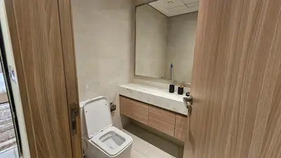 a bathroom with a toilet and a sink at Luxury Studio with Burj Khalifa View in Dubai